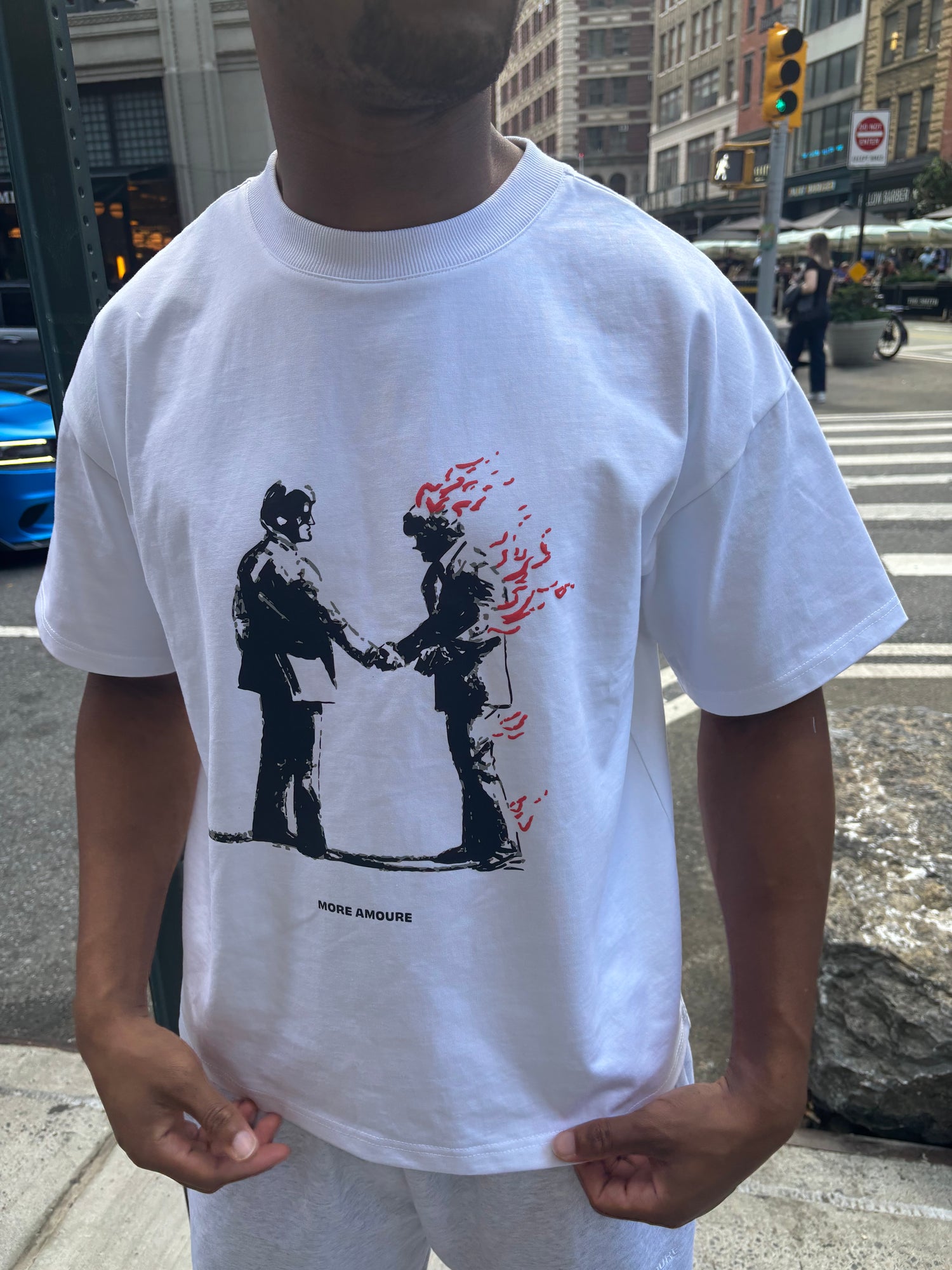 More amoure pyro pact T-shirt with two men shaking hands while one is on fire. 